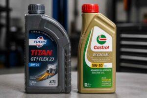 Dwie butelki oleju silnikowego Fuchs Titan i Castrol Edge 5W-30 na blacie roboczym